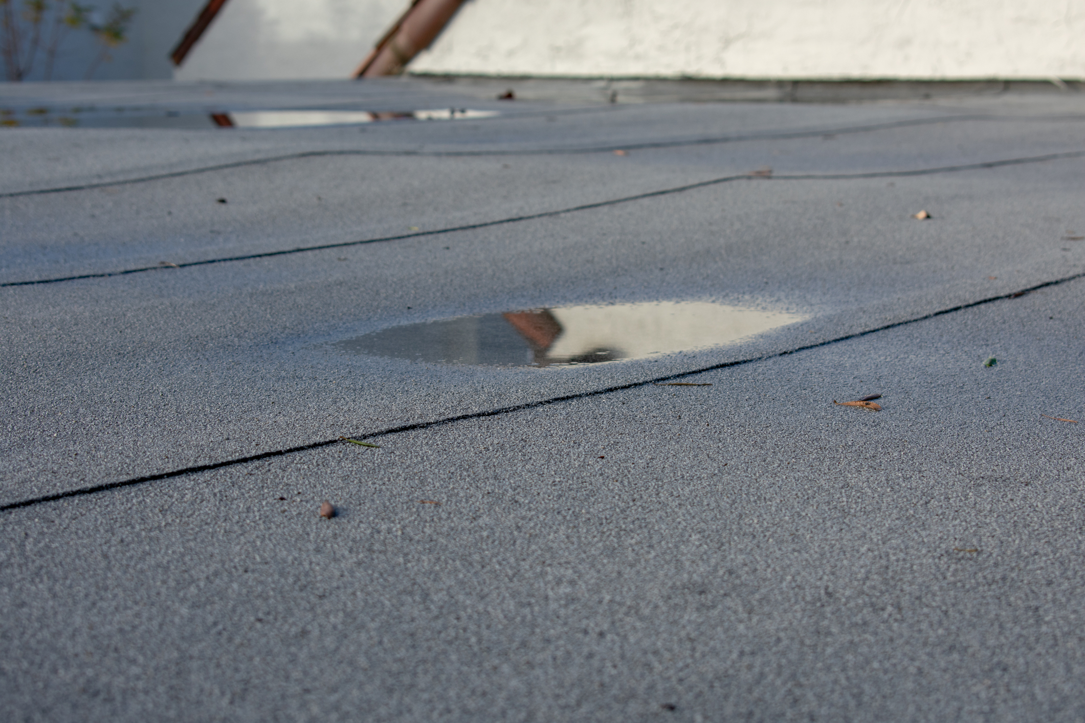 Ponding water on a flat roof is a sign that repair may be needed.